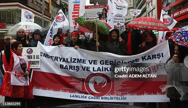 Turkish members of labor unions and civil society groups shout slogans before upcoming International Women's Day in Ankara on March 5, 2016. The...