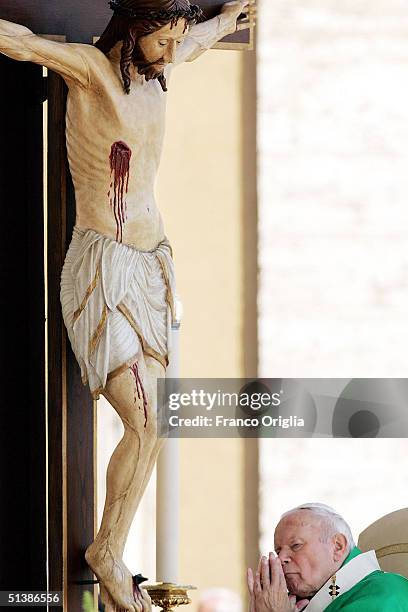 Pope John Paul II prays during a beatification ceremony in St. Peter's Square October 3 , 2004 in Vatican City. Pope John Paul II named five...