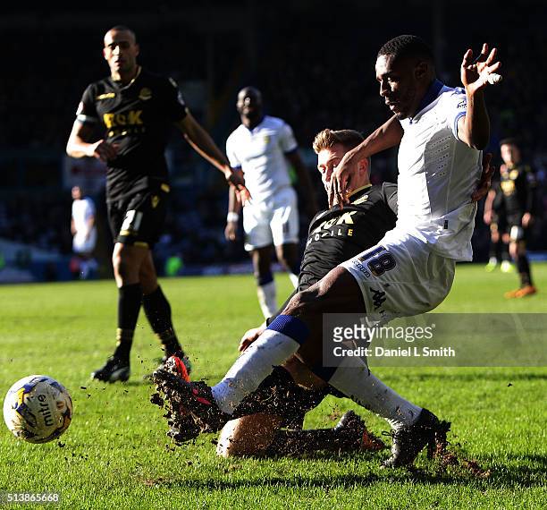 Josh Vela of Bolton Wanderers FC tackles Mustapha Carayol of Leeds United FC for the ball during the Sky Bet Championship League match between Leeds...