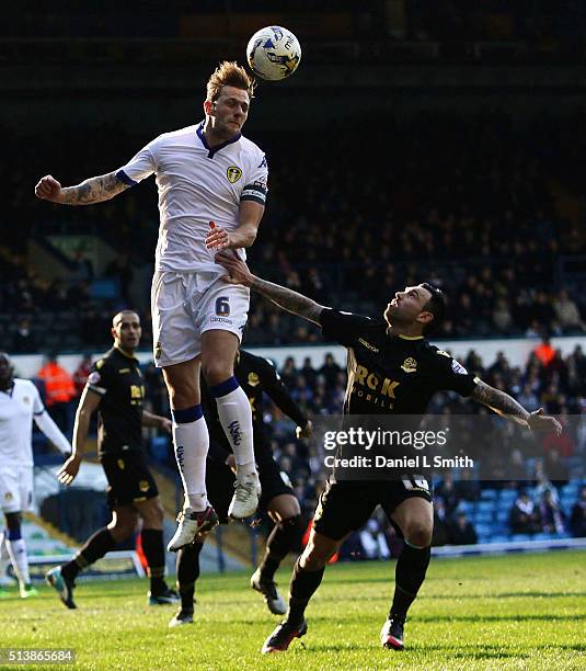 Liam Cooper of Leeds United FC heads the ball over Mark Davies of Bolton Wanderers FC during the Sky Bet Championship League match between Leeds...