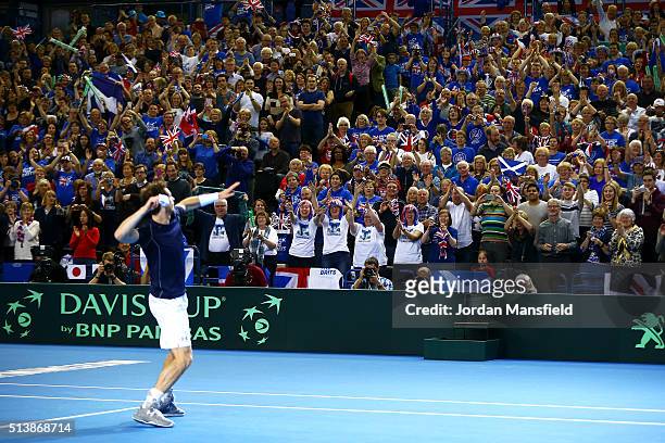 Andy Murray of Great Britain throws his sweatbands into the crowd following victory during the doubles match against Yoshihito Nishioka and Yasutaka...
