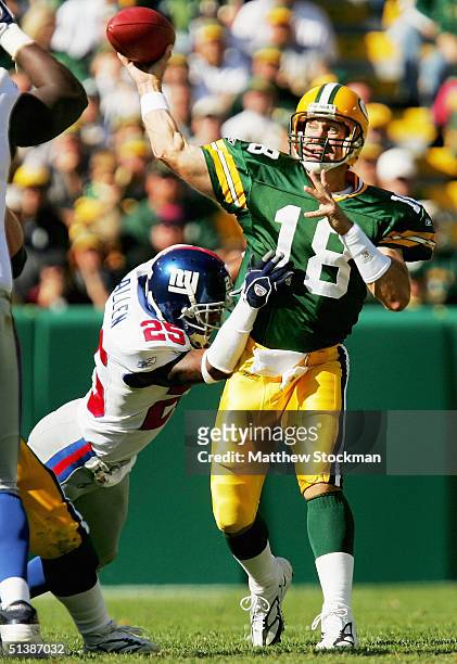 Doug Pederson of the Green Bay Packers throws under pressure by Will Allen of the New York Giants October 3, 2004 at Lambeau Field in Green Bay,...