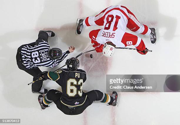 Blake Speers of the Sault Ste Marie Greyhounds takes a faceoff against Cliff Pu of the London Knights during an OHL game at Budweiser Gardens on...