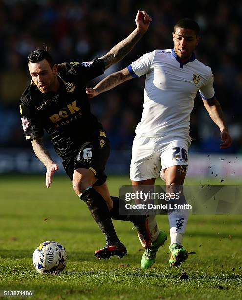 Mark Davies of Bolton Wanderers FC under pressure from Charlie Taylor of Leeds United FC during the Sky Bet Championship League match between Leeds...
