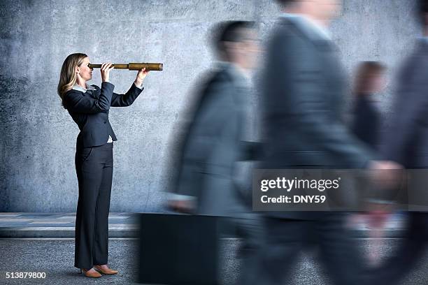 businesswoman looking through spyglass in the direction everyone is walking - hand held telescope stock pictures, royalty-free photos & images