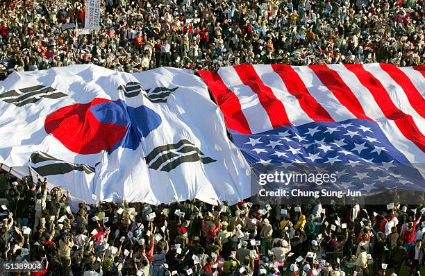 South Korean conservative protesters display huge US and South Korean national flags during an anti-North Korea rally in front of city hall on...
