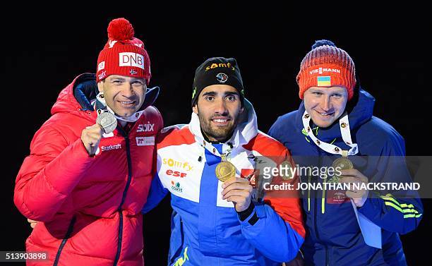 Second placed Ole Einar Bjorndalen of Norway, winner Martin Fourcade of France, third placed Ukraine's Sergey Semenov pose during a medal ceremony...