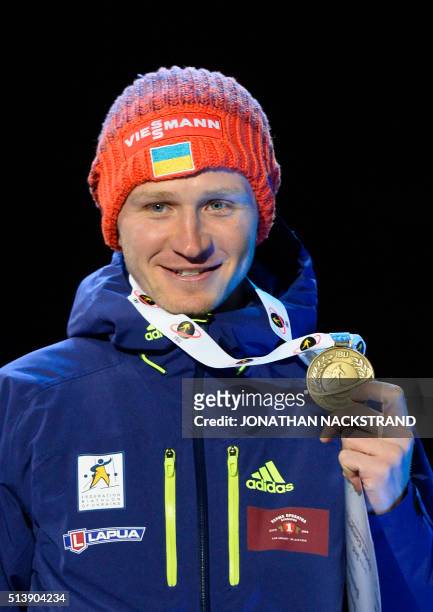 Third placed Ukraine's Sergey Semenov poses during a medal ceremony after the Men's 10 km Sprint event at the IBU World Championships Biathlon...