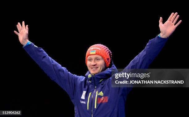 Third placed Ukraine's Sergey Semenov poses during a medal ceremony after the Men's 10 km Sprint event at the IBU World Championships Biathlon...