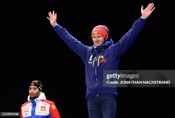 Winner Martin Fourcade of France AND third placed Ukraine's Sergey Semenov pose during a medal ceremony after the Men's 10 km Sprint event at the IBU...