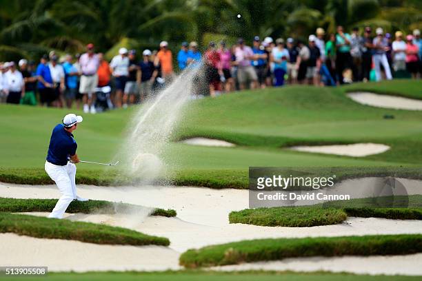 Paul Casey of England takes his third shot on the first hole during the third round of the World Golf Championships-Cadillac Championship at Trump...