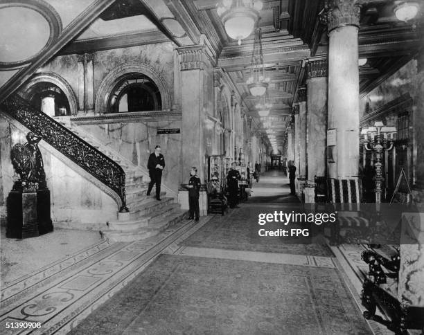 Members of the Waldorf-Astoria hotel staff stand in Peacock Alley awaiting guests, New York, New York, 1910s. Peacock Alley was a three hundred foot...