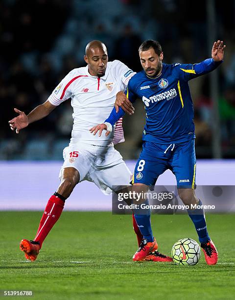 Steven N,Kemboanza Mike N,Zonzi of Sevilla FC competes for the ball with Mehdi Lacen of Getafe CF during the La Liga match between Getafe CF and...