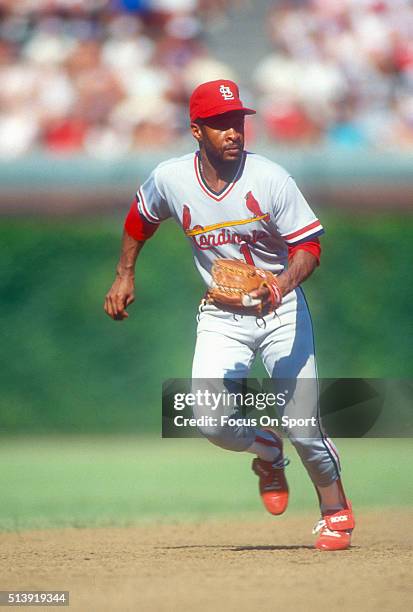 Ozzie Smith of the St. Louis Cardinals in action against the Chicago Cubs during a Major League baseball game circa 1990 at Wrigley Field in Chicago,...