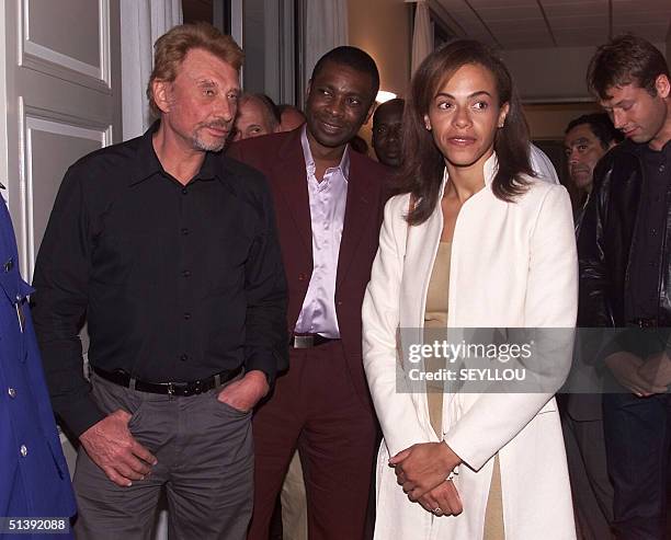 French singer Johnny Hallyday is seen with Senegalese singer Youssou N'Dour and Sindyeli Wade , daughter of Senegal's President Abdoulaye Wade at the...