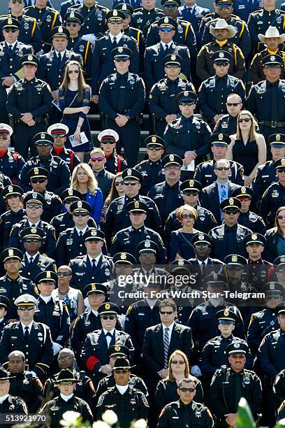 Hundreds of officers from different agencies at Pennington Field in Fort Worth, Texas, attend a memorial service for Euless, Texas, police officer...