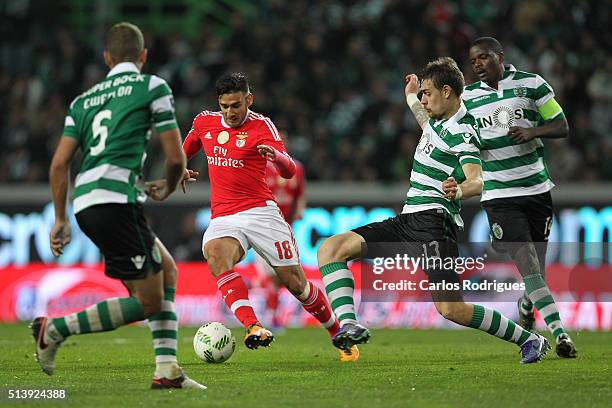 Benfica's forward Eduardo Salvio tries to escape Sporting's defender Sebastian Coates during the match between Sporting CP and SL Benfica for the...