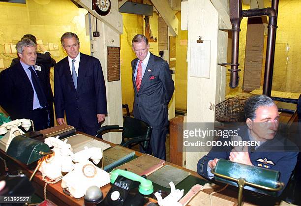 President George W. Bush is guided through the map room of Winston Churchill's Cabinet War Rooms by Philip Reed , Curator of the museum in London, 19...