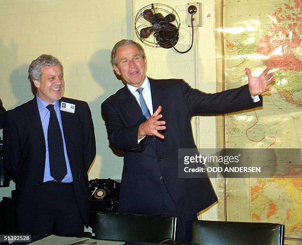 President George W. Bush and Philip Reed , Curator of the Winston Churchill's Cabinet War Rooms in London, shares a laugh 19 July 2001 as they visit...