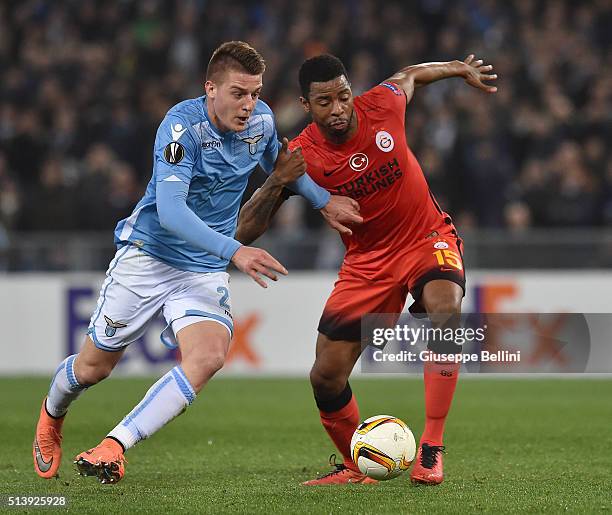 Sergej Milinkovic-Savic of SS Lazio and Ryan Donk of Galatasaray AS in action during the UEFA Europa League Round of 32 second leg match between SS...