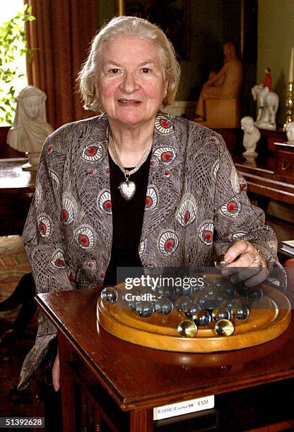 File photo dated January 2001 shows British author P.D. James playing solitaire in her London home. AFP PHOTO