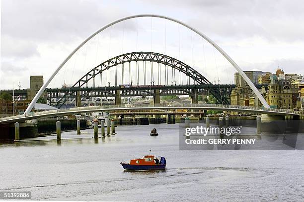 The Millennium Bridge, the rotating bridge, nears completion 05 September 2001, across the river Tyne in front of the famous Tyne Bridge in...