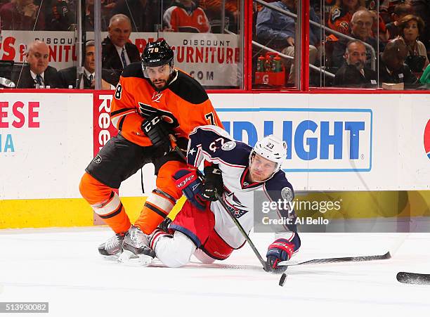 David Clarkson of the Columbus Blue Jackets falls with the puck as Pierre-Edouard Bellemare of the Philadelphia Flyers defends during their game at...