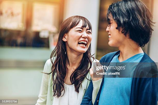 asian ethnicity couple laughing - couple close up street stock pictures, royalty-free photos & images