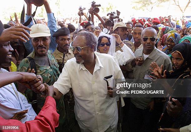 Somaliland "president" Mohamed Ibrahim Egal shakes hands with voters waiting to cast their ballot at a polling station in Hargeisa, Somalia, 31 May...