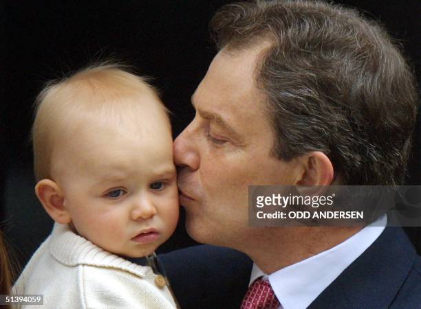 Britain's Prime Minister Tony Blair kisses his son Leo on the step to No. 10 Downing Street London 08 June 2001. Blair posed with his family on the...