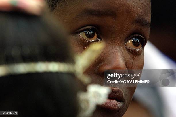 Child infected from the Nkosi Johnson Haven -- a shelter for HIV-positive mothers and children -- cries 09 June 2001 during the funeral of Nkosi...
