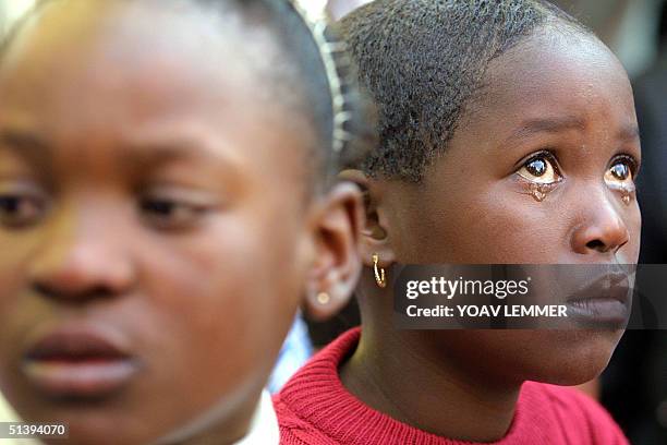 Child from the Nkosi Johnson Haven -- a shelter for HIV-positive mothers and children -- cries 09 June 2001 during the funeral of Nkosi Johnson, the...
