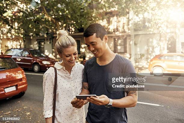 they're on their way now... - couple with smart phone stock pictures, royalty-free photos & images