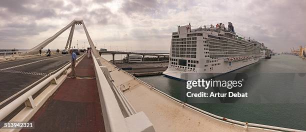 Panorama on the harbor of Barcelona city with Mediterranean Sea, big ship cruise and the Europa Bridge.