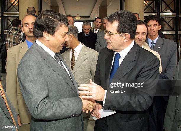 European Commission President Romano Prodi shakes hands with Algerian Prime Minister Ali Benflis 13 January 2001 before signing economic accords with...