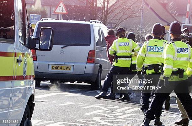 Protesters are grabbed by police as they rush the van carrying 42-year-old Roy Whiting as it leaves Chichester Magistrates court, 07 February 2001....