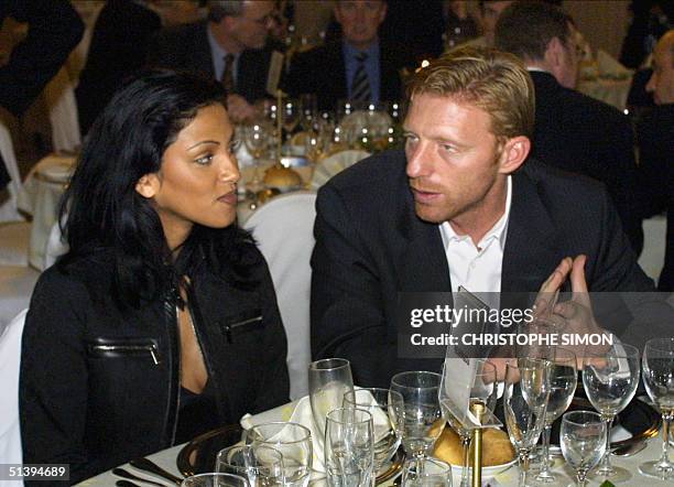 German tennis champion Boris Becker, who recently formally ended his seven-year marriage, talks to his new girl-friend German rap singer Sabrina...