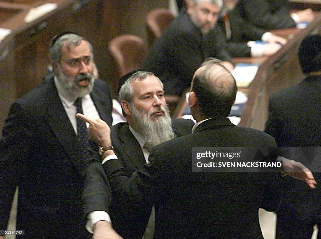 Shas MP's Nissim Zeev (L), Nissim Dahan (C) argues
