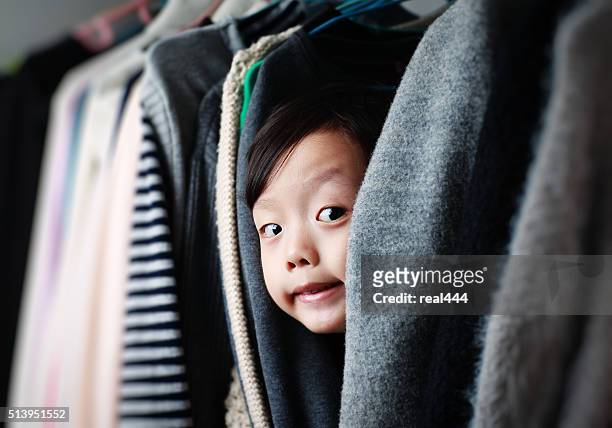 child playing in the closet - misbehaving children stock pictures, royalty-free photos & images