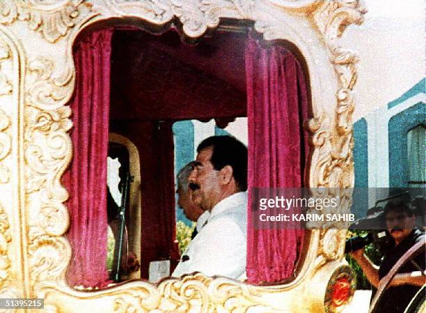 Iraqi President Saddam Hussein sits in a carriage coach 29 April 1993. The coach was presented to him as a gift 29 April 1993 in celebration of his...