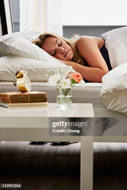 woman asleep in bed - alarm clock close up stock pictures, royalty-free photos & images