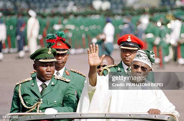 Nigerian President Olusegun Obasanjo waves to the crow at the Eagle Square in Abuja 01 October 2000. Obasanjo arrived at the 40th independence...