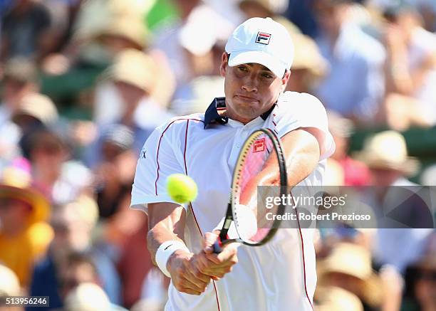 John Isner of the United States plays a backhand in his match against Bernard Tomic of Australia during the Davis Cup tie between Australia and the...