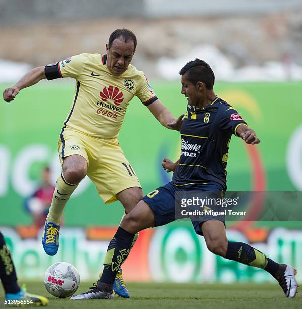 Cuauhtemoc Blanco of America fights for the ball with Ignacio Gonzalez of Morelia during the 9th round match between America and Morelia as part of...