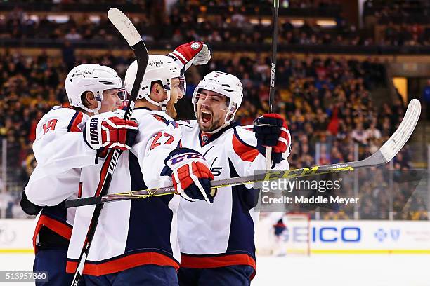 Matt Niskanen of the Washington Capitals congratulates Karl Alzner after he scored against the Boston Bruins during the second period at TD Garden on...