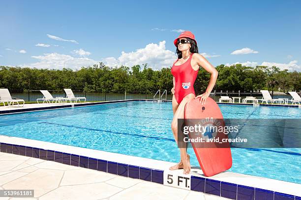 female lifeguard at attention by pool - lifeguard stock pictures, royalty-free photos & images