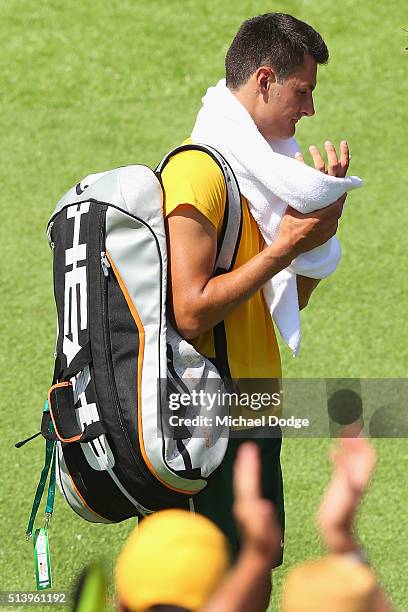 Bernard Tomic of Australia walks off after losing his match against John Isner of the USA during the Davis Cup tie between Australia and the United...