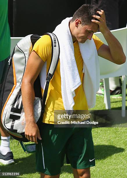 Bernard Tomic of Australia walks off after losing his match against John Isner of the USA during the Davis Cup tie between Australia and the United...