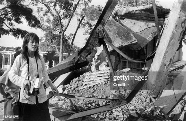 Actress and peace activist Jane Fonda, holding a camera, visits 25 July 1972 a Hanoi site bombed by US airplanes. Fonda's trip to North Vietnam was...