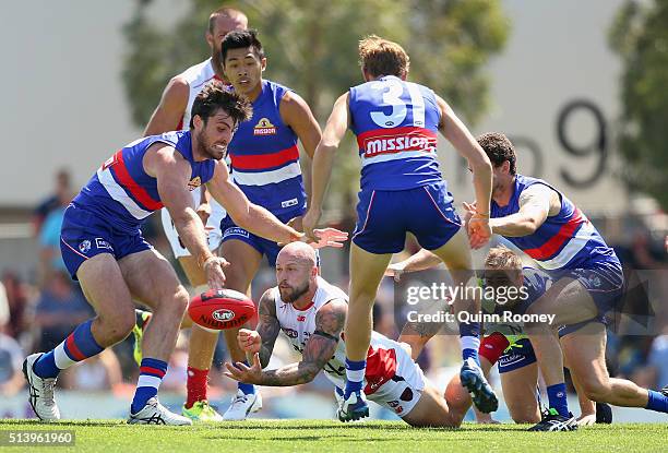 Nathan Jones of the Demons handballs out of a pack during the 2016 AFL NAB Challenge match between the Western Bulldogs and the Melbourne Demons at...